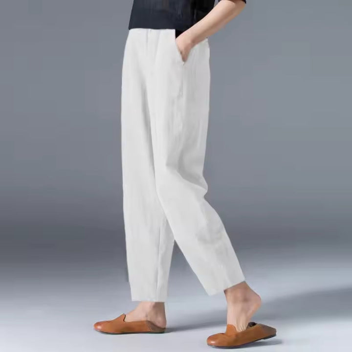 Black lightweight summer trousers with a relaxed fit and tapered ankle, styled casually