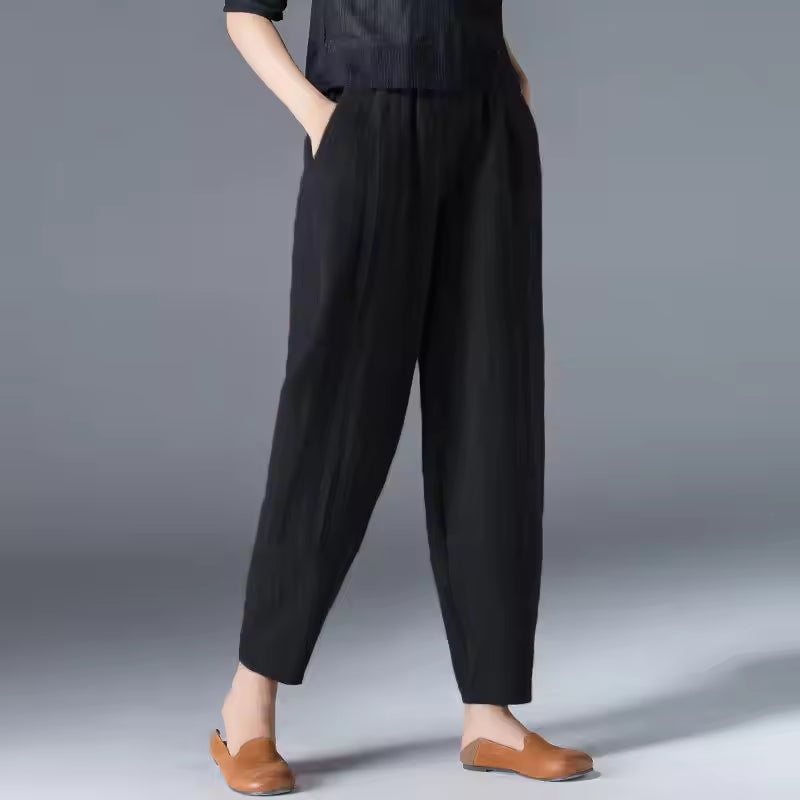 Woman in sky blue summer trousers walking outdoors, showcasing the breezy movement of the fabric