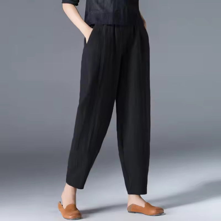 Woman in sky blue summer trousers walking outdoors, showcasing the breezy movement of the fabric