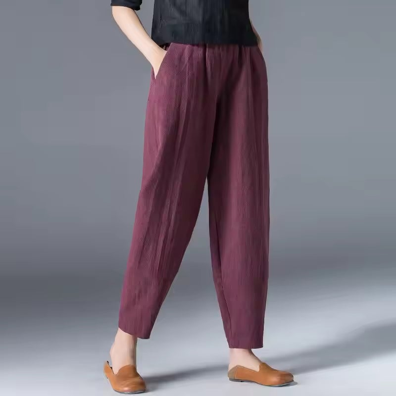 Side view of lightweight summer trousers highlighting the elastic comfort waistband and fluid drape
