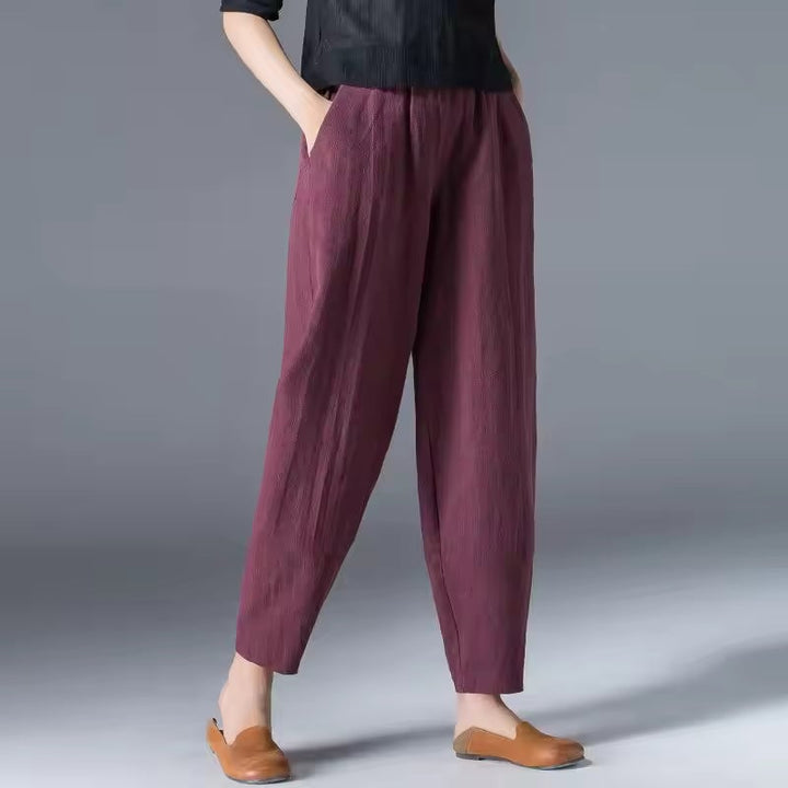 Side view of lightweight summer trousers highlighting the elastic comfort waistband and fluid drape