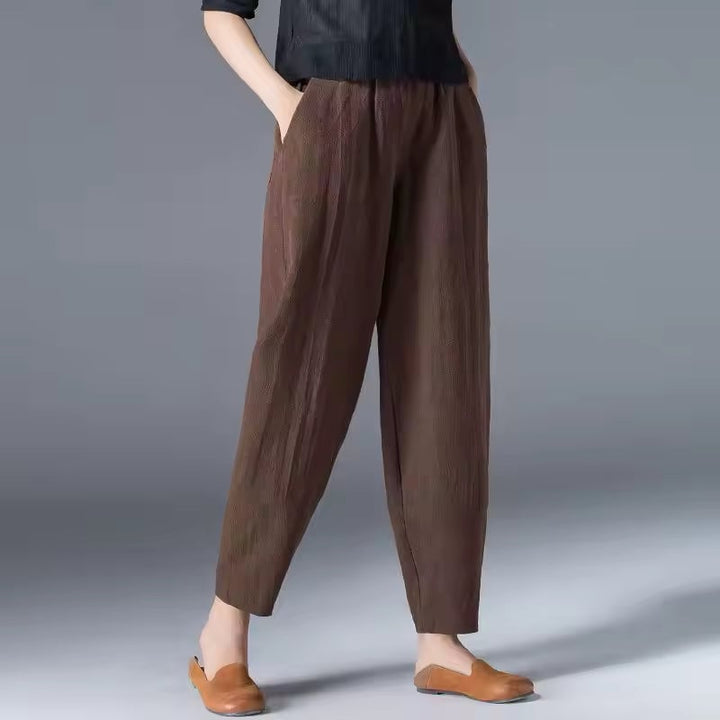 Flat lay of multiple color options for the Desiree lightweight summer trousers including beige and burgundy