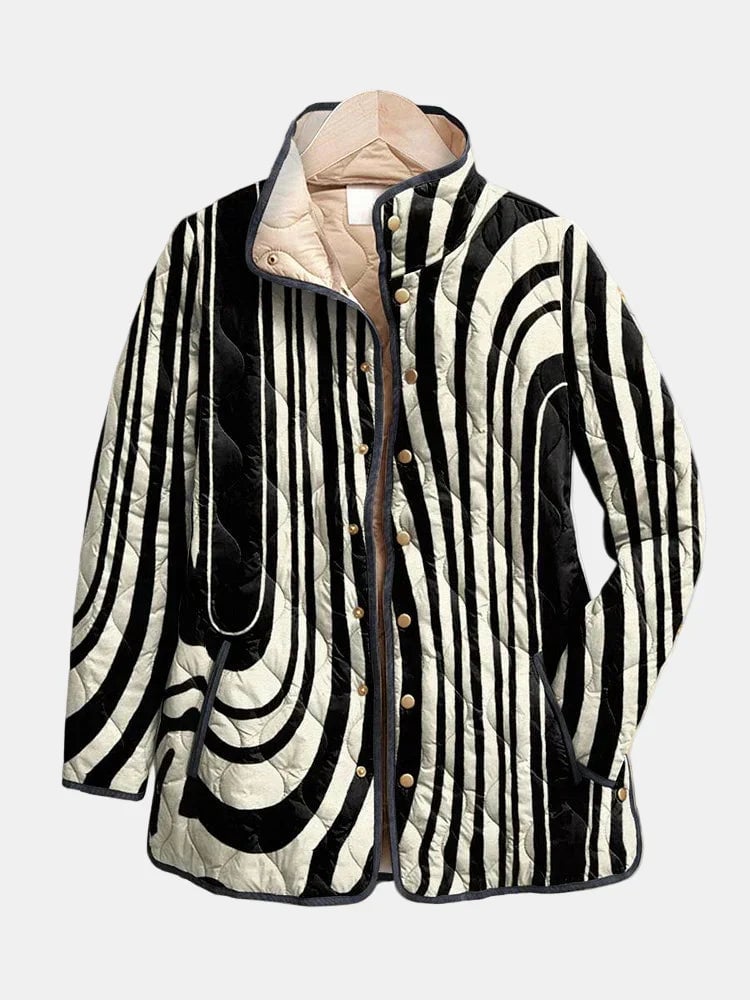Woman wearing a multicolor abstract geometric quilted jacket with a relaxed casual fit