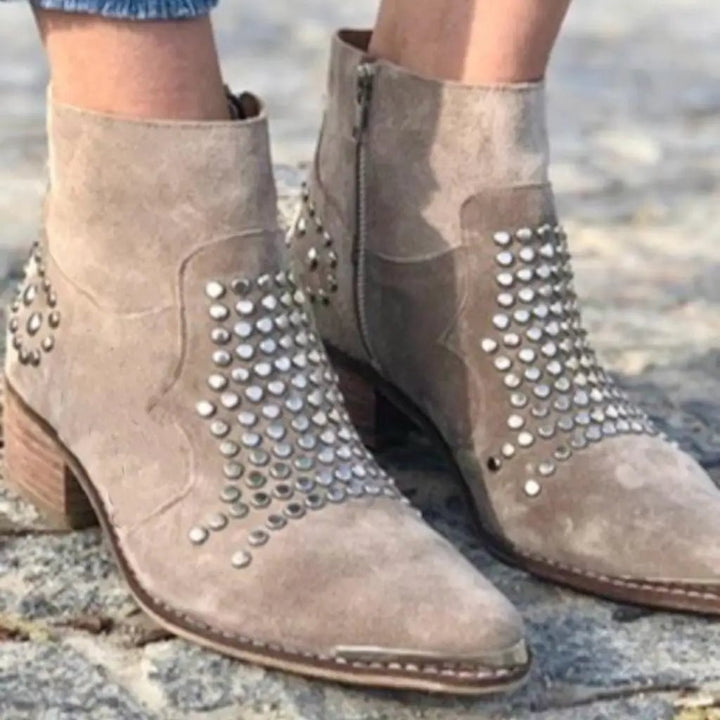 Gray studded edge boots with metal stud detail along the sole edge, front view