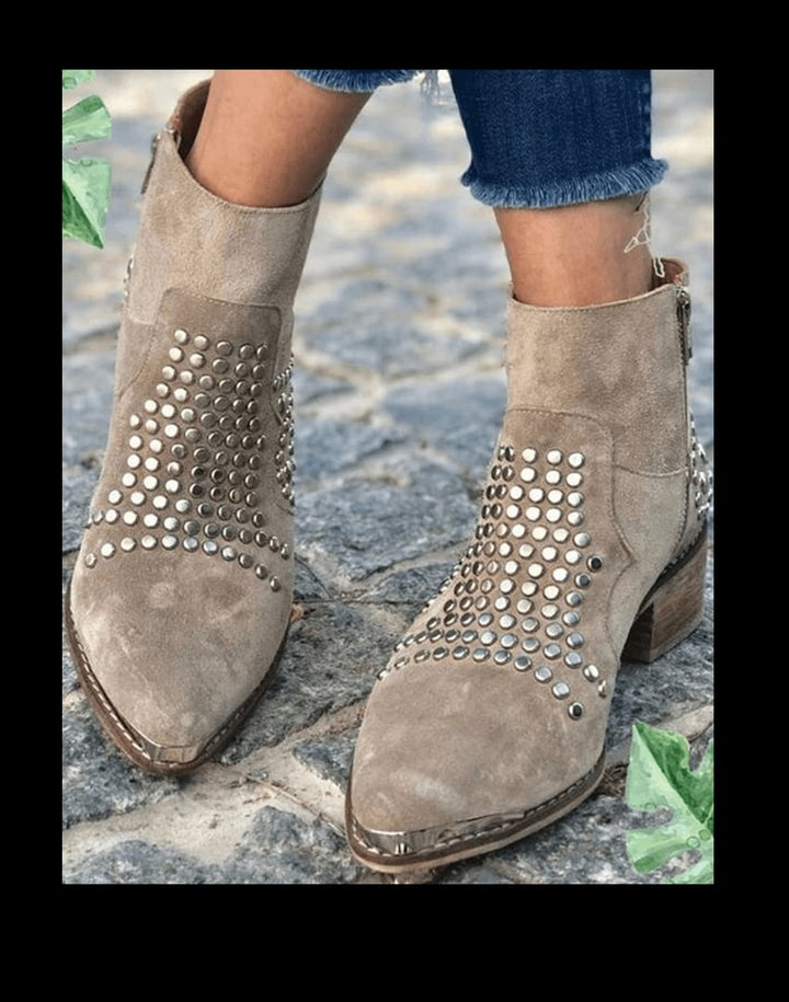 Close-up of metal stud accents on the edge of gray women's boots