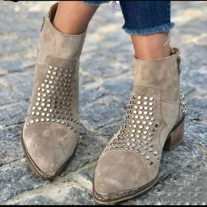 Pair of gray women's studded edge boots shown from above on neutral background