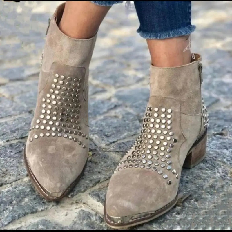Pair of gray women's studded edge boots shown from above on neutral background