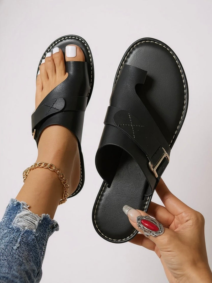Diana toe-loop slides in black styled with casual warm-weather outfit, side view showing lightweight profile