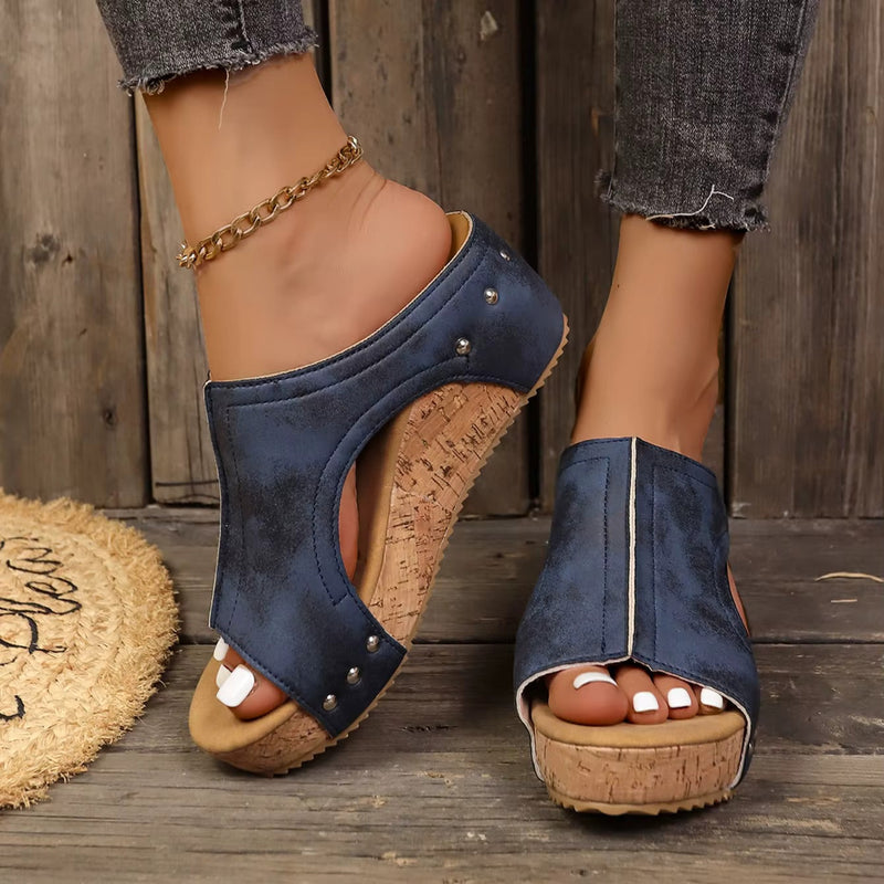 Close-up of metallic stud embellishments on Diana wedge sandal straps