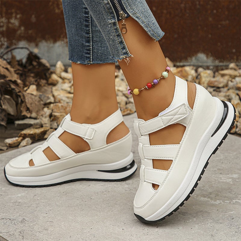 Diane sneakers in black styled with casual denim outfit on a city sidewalk