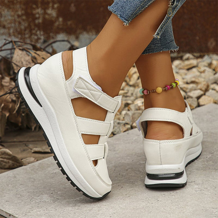 Top-down view of Diane white sneakers showing adjustable strap and clean silhouette