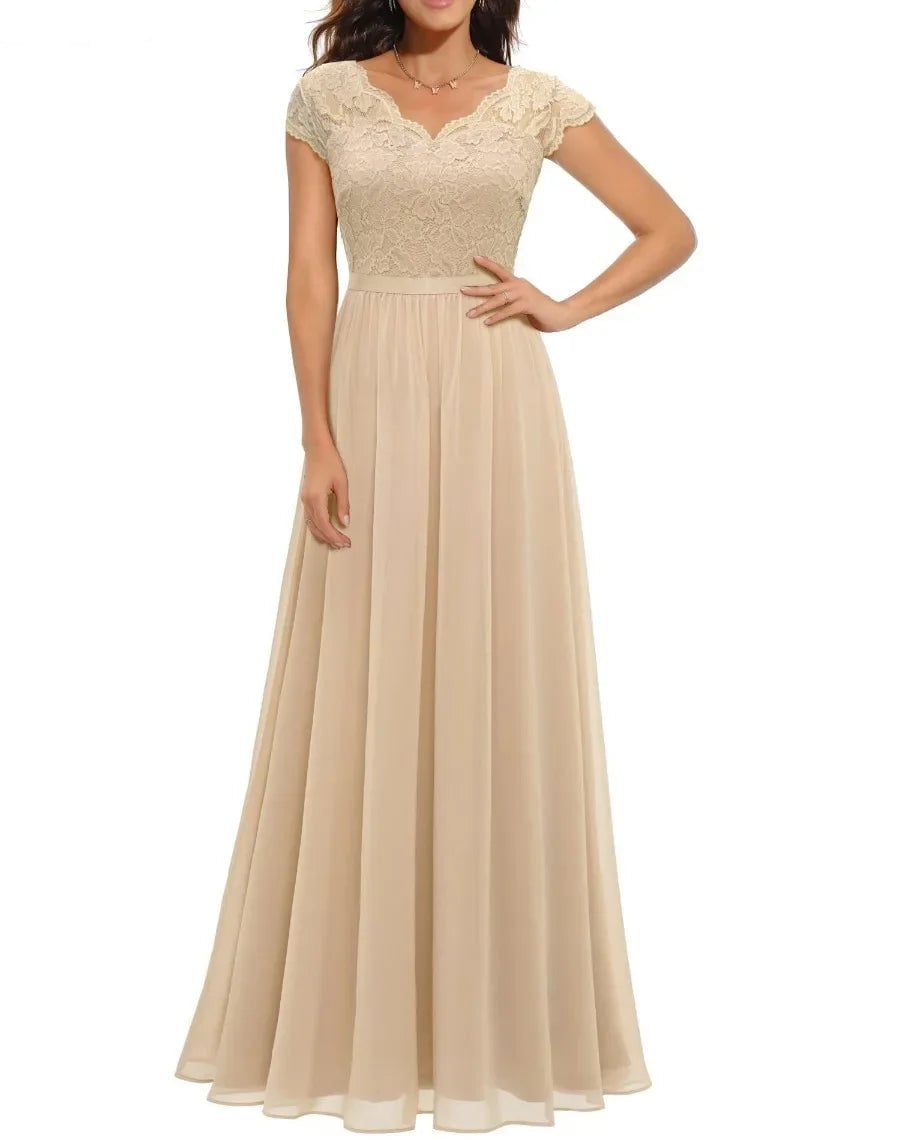 Front view of a women's lace maxi dress in champagne with delicate bodice detailing and graceful draped skirt