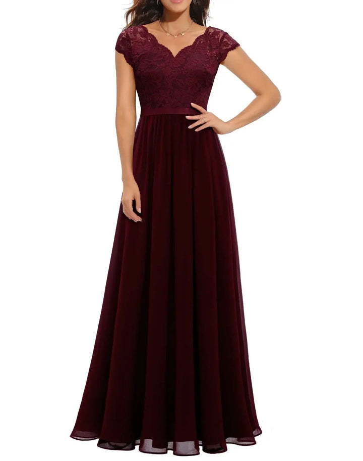 Side view of a women's elegant lace long dress in pink, highlighting the flowing draped skirt