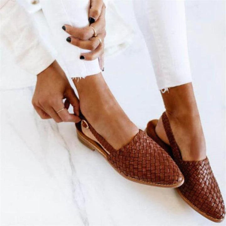 Elegant woven vegan leather ballet flats in dark brown with a rounded toe and low-profile sole, shown from a front three-quarter angle