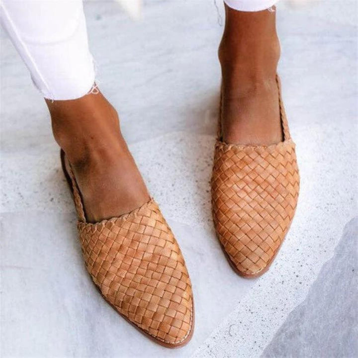 Woven vegan leather ballet flats in green styled with a flowy summer dress, shown on foot