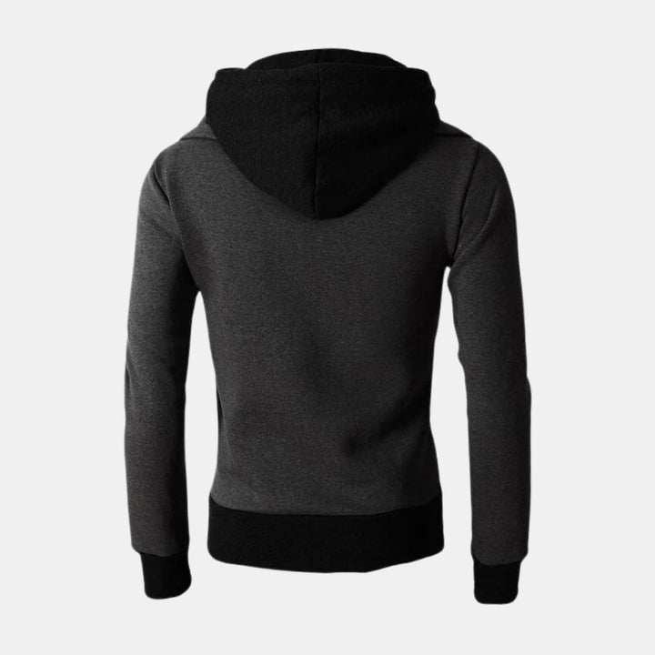 Woman wearing the Dorian Sport Jacket in black with a high-neck hood pulled up for extra wind protection