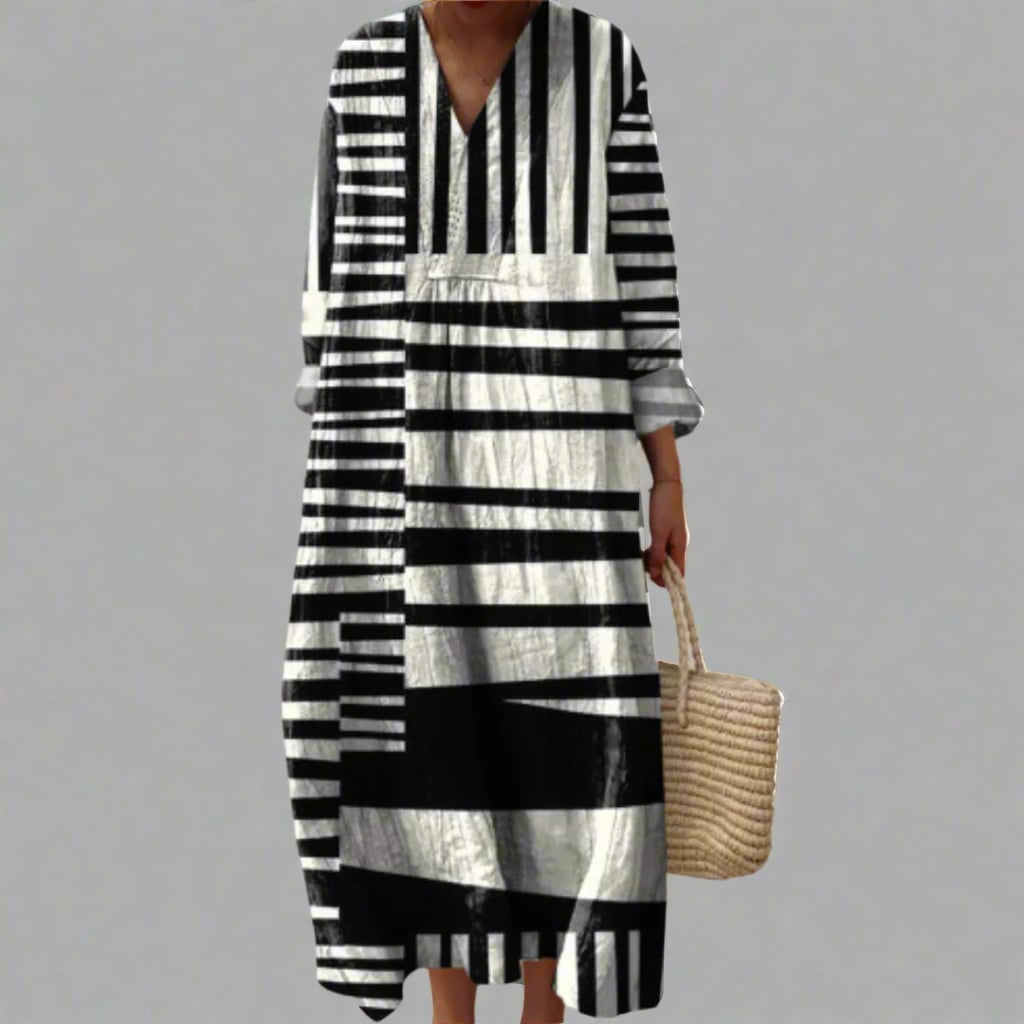 Model wearing an elegant geometric print dress with a fluid silhouette in a bold dream-inspired pattern