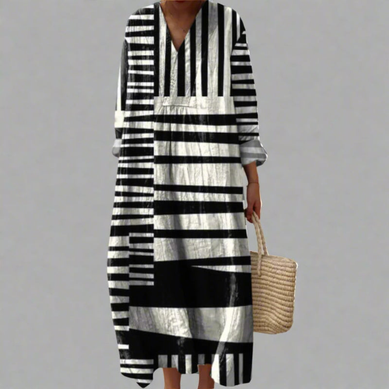 Model wearing an elegant geometric print dress with a fluid silhouette in a bold dream-inspired pattern