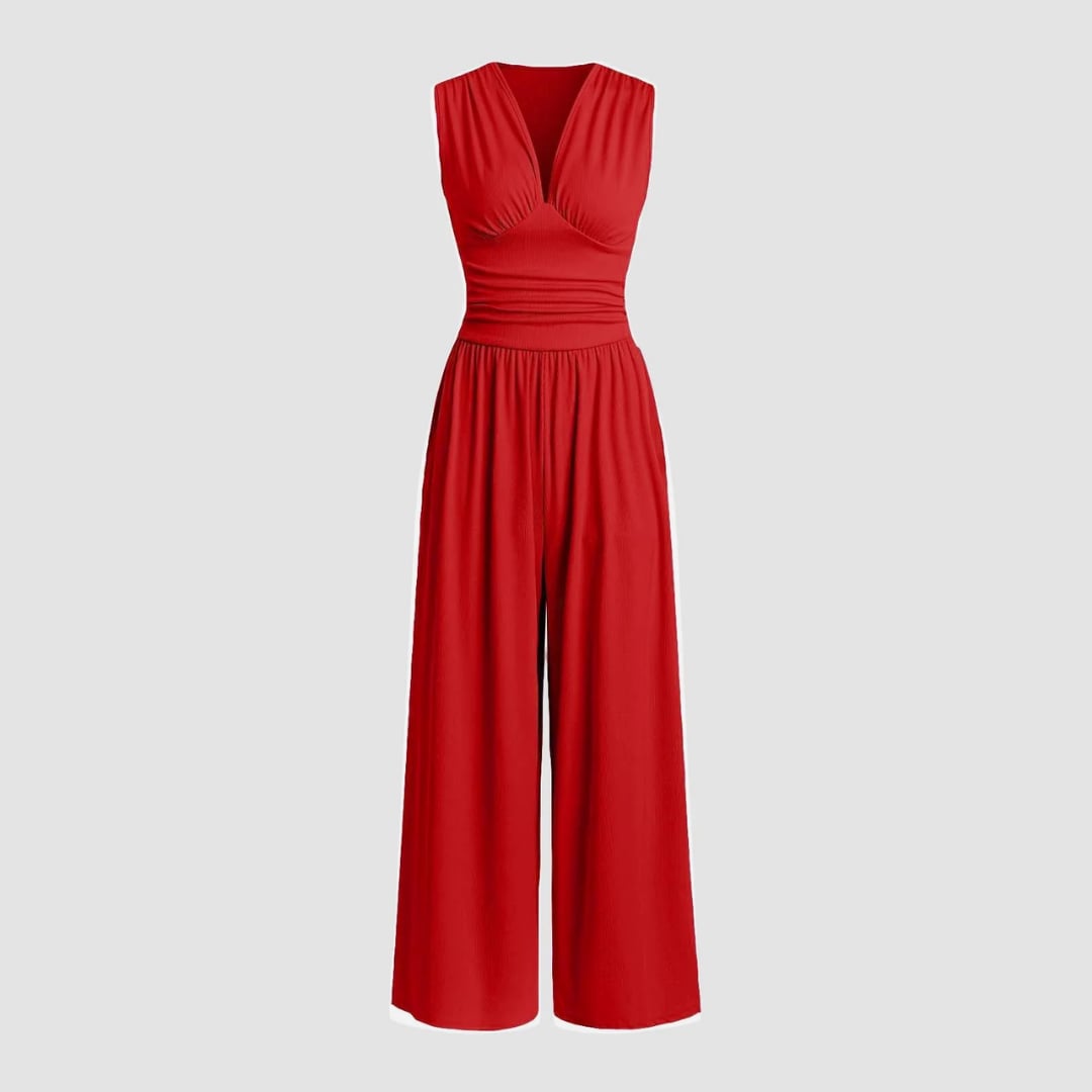 Woman wearing a red sleeveless wide-leg ribbed stretch jumpsuit with a defined waistline, front view