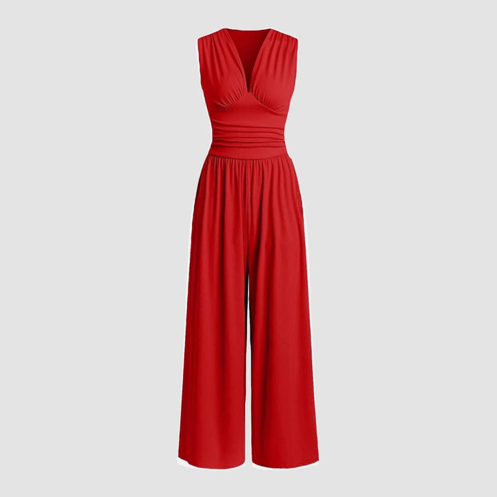 Woman wearing a red sleeveless wide-leg ribbed stretch jumpsuit with a defined waistline, front view