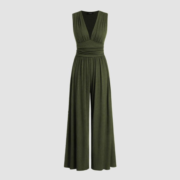 Woman in a black sleeveless wide-leg jumpsuit showing the flowing wide-leg silhouette