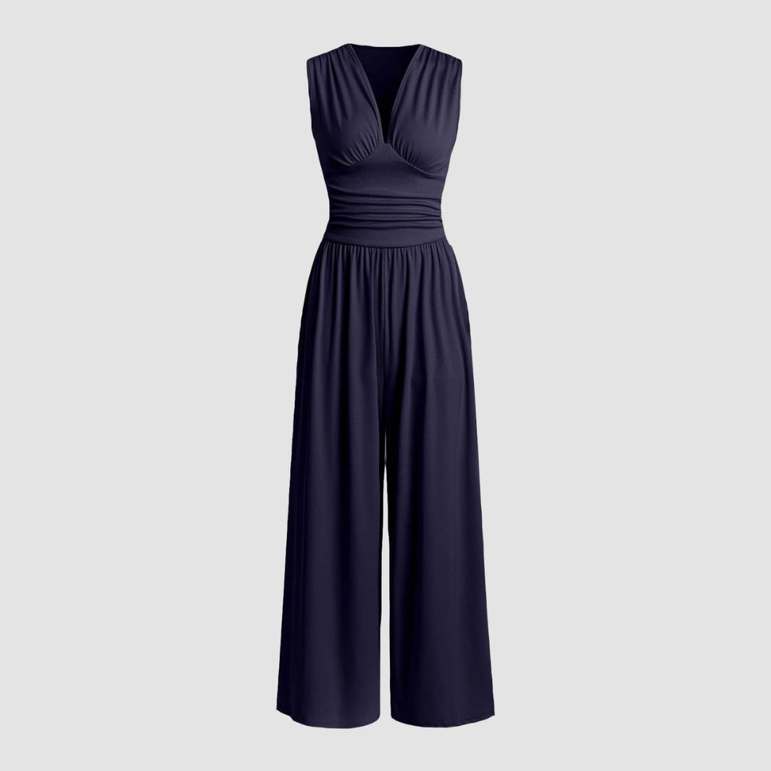 Woman in a beige sleeveless wide-leg jumpsuit styled with heels for an evening look