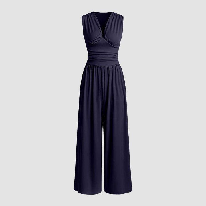 Woman in a beige sleeveless wide-leg jumpsuit styled with heels for an evening look