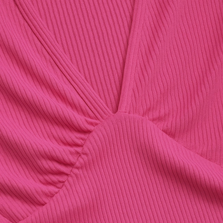 Model in a wide-leg jumpsuit showing the defined waistline detail up close