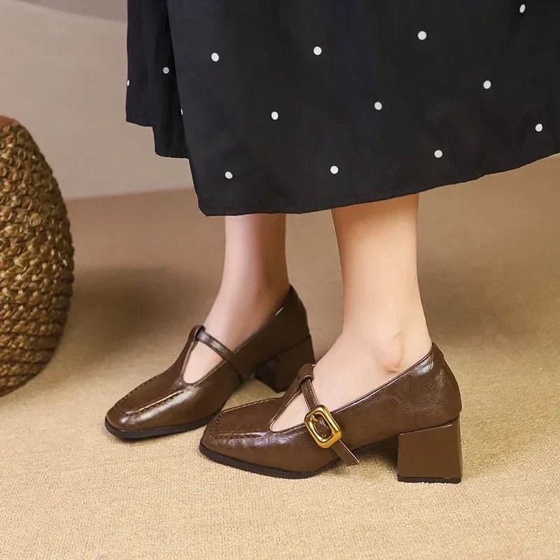 Odette block heel mary jane shoes in black, angled front view showing square toe and gold buckle detail