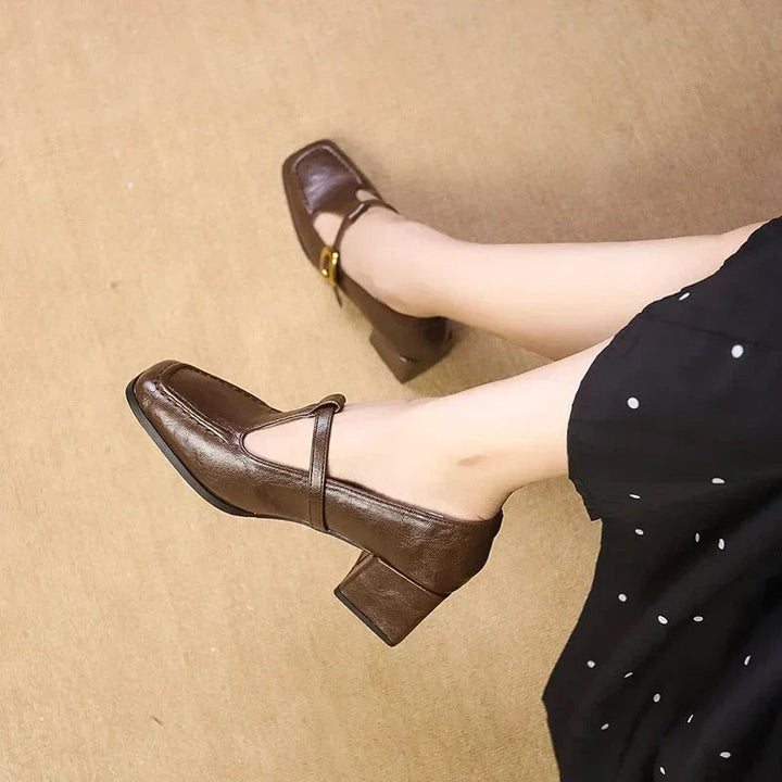Close-up of gold-dotted buckle strap on Odette mary jane heels in brown croc-embossed leather