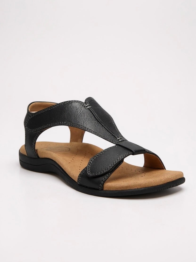 Dove women's flat cushioned T-strap sandal in a neutral colorway, front three-quarter view