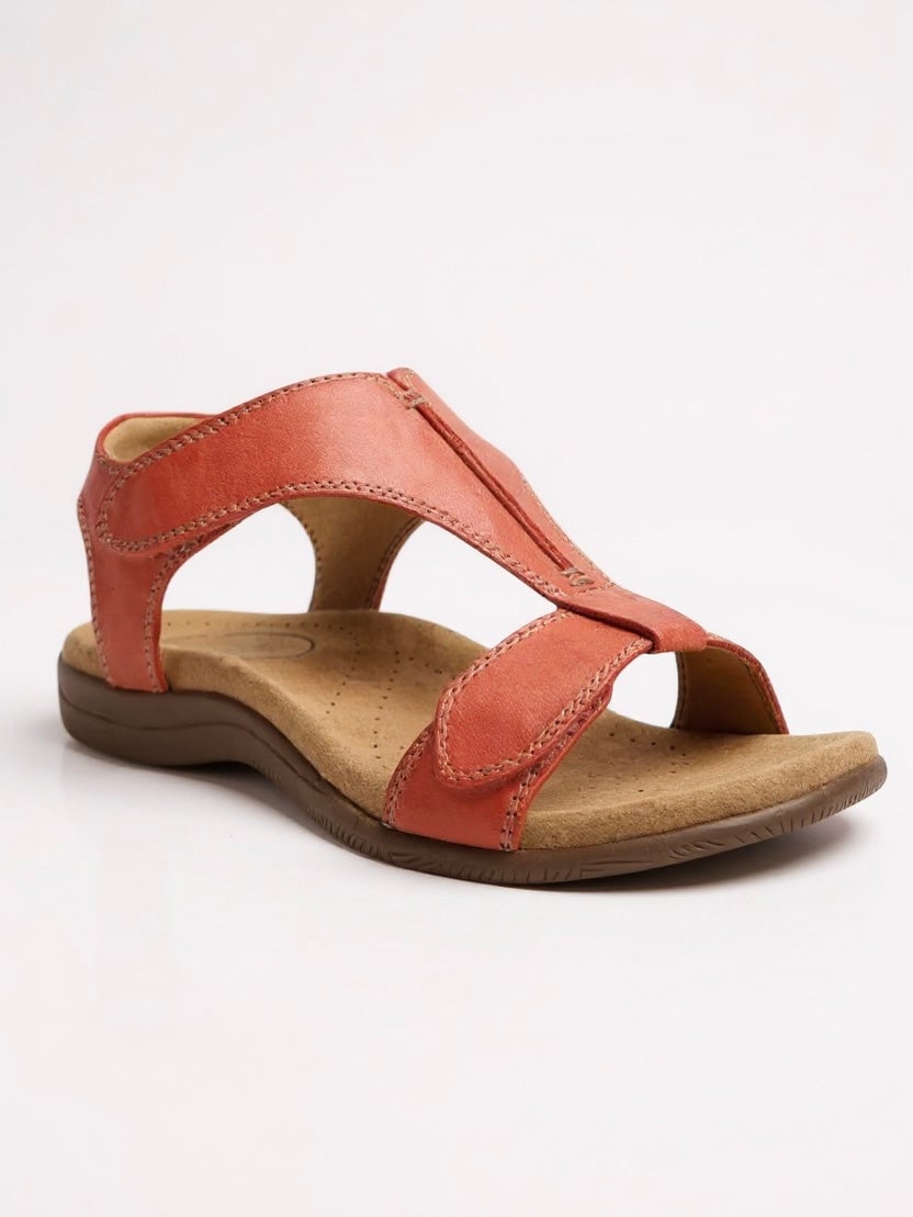 Close-up of the cushioned footbed and T-strap strap detail on the Dove flat sandal