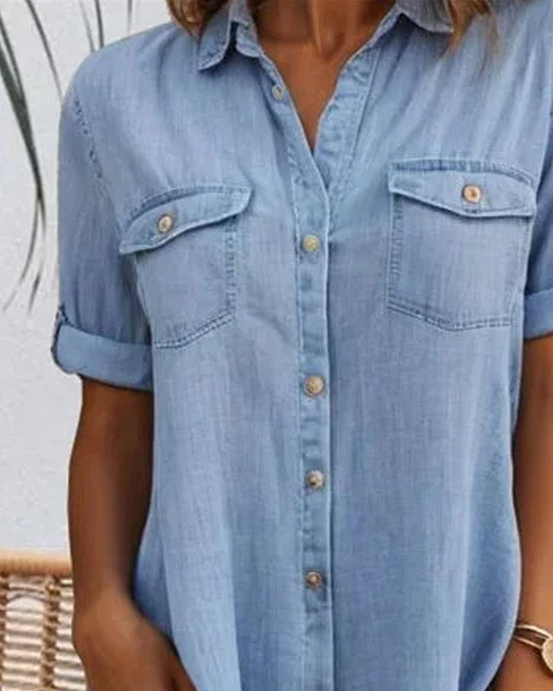 Close-up of the button-down front and rolled sleeve detail on the denim-look dress