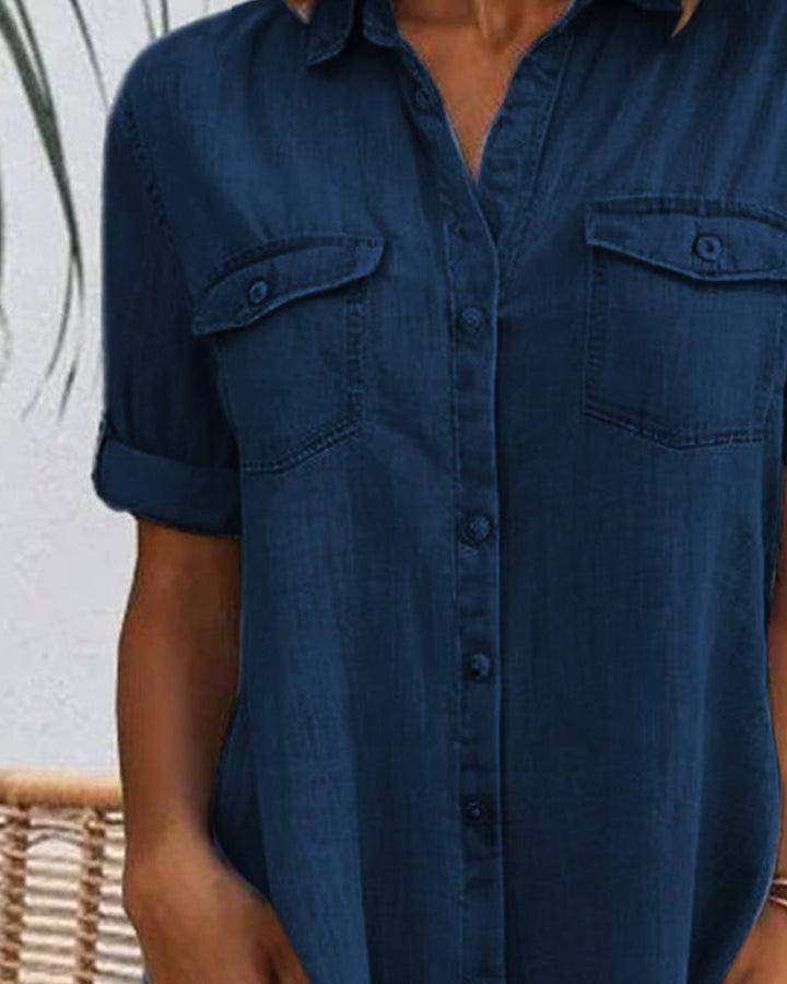 Lifestyle shot of woman in light blue denim-look dress at a casual brunch setting