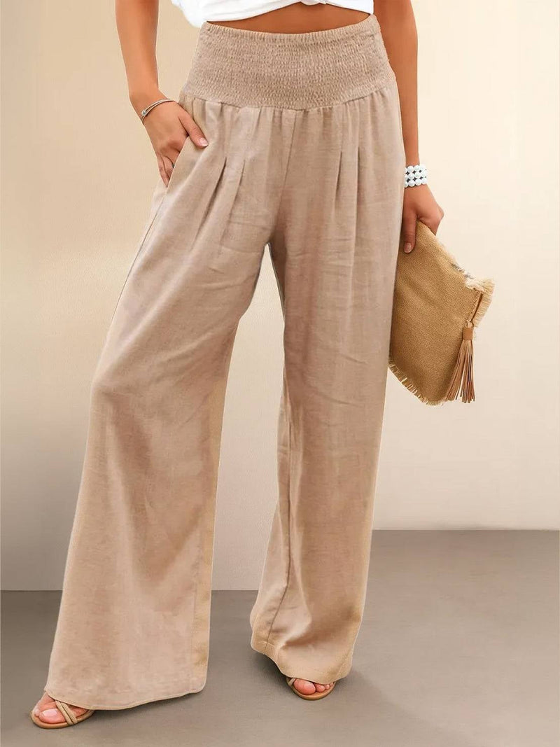 Front view of high waist wide leg smocked pants in khaki with front pleat detail
