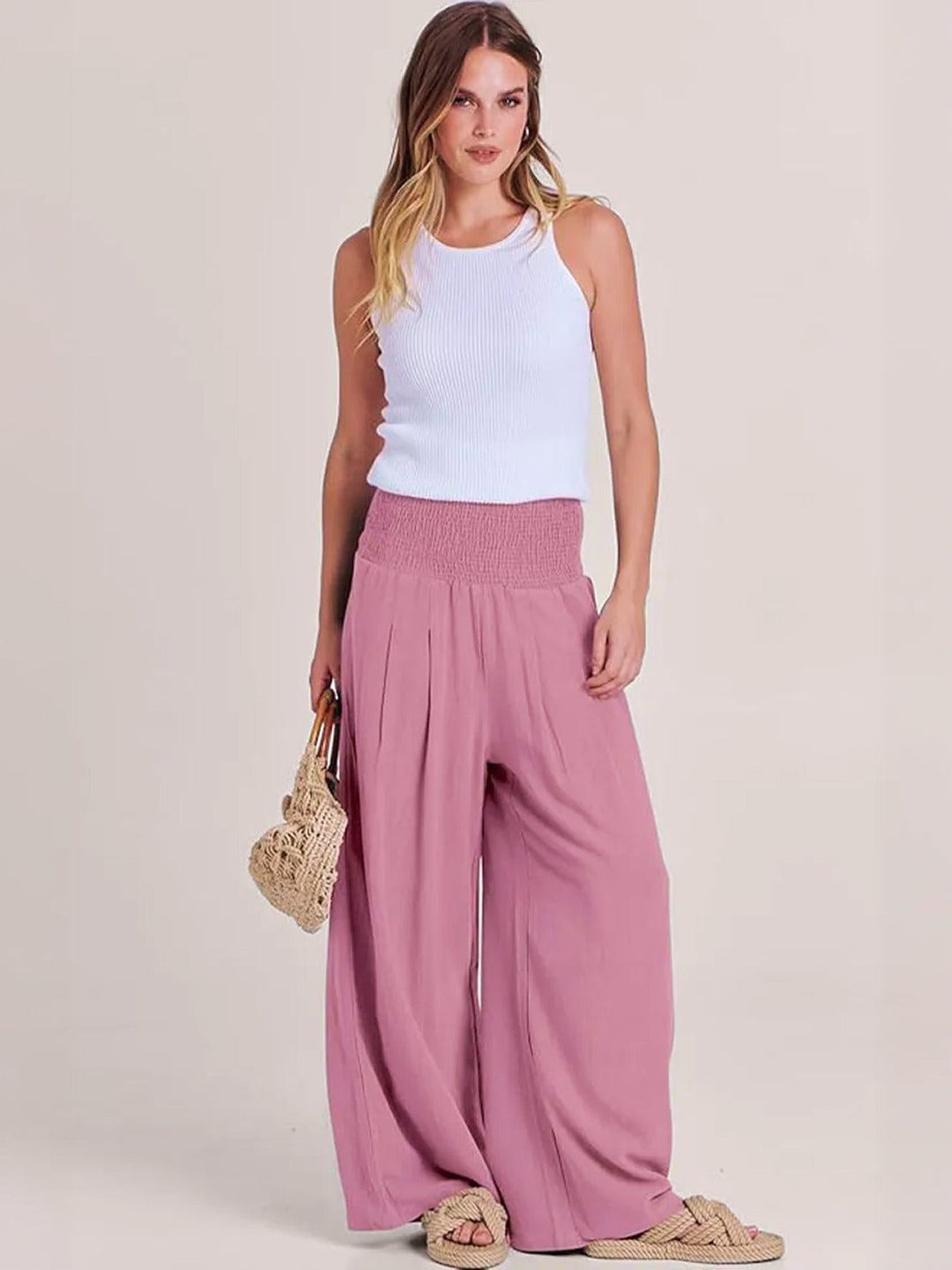 Back view of light pink wide leg smocked waistband pants