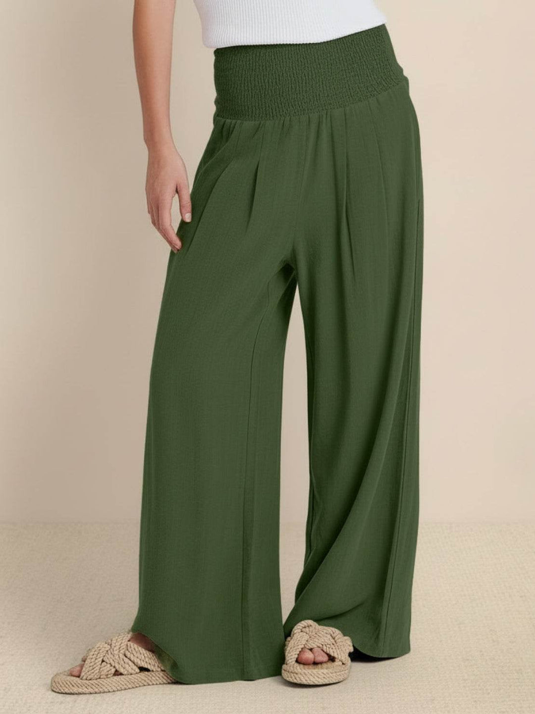 Close-up of smocked waistband on army green wide leg pants