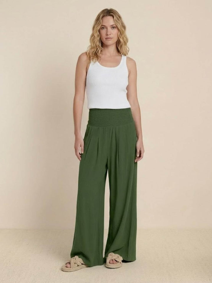 Model wearing army green wide leg pants with a cropped knit top