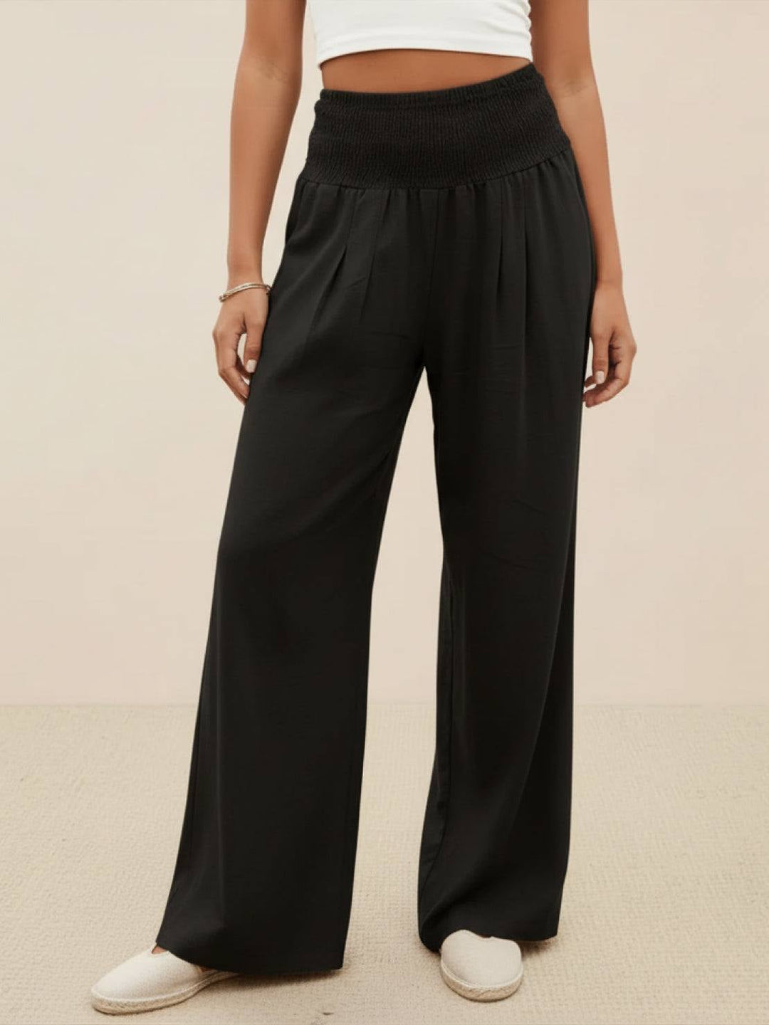 Back view of black high waist wide leg smocked pants
