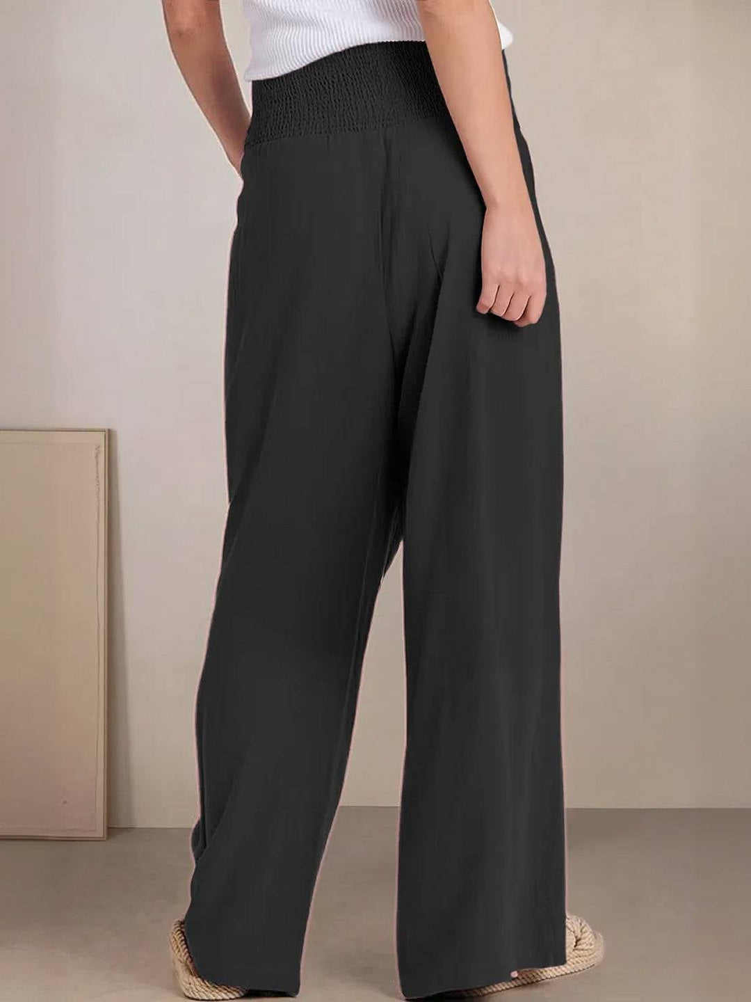 Close-up of side seam pocket detail on wide leg linen-look pants