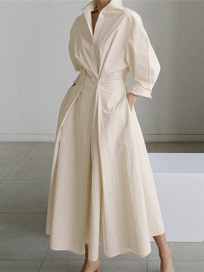 Model wearing the Eden elegant long dress in beige, showing the flowing silhouette and figure-flattering fit