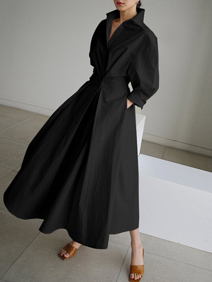 Side view of the Eden elegant long dress in black highlighting the elegant flowing skirt