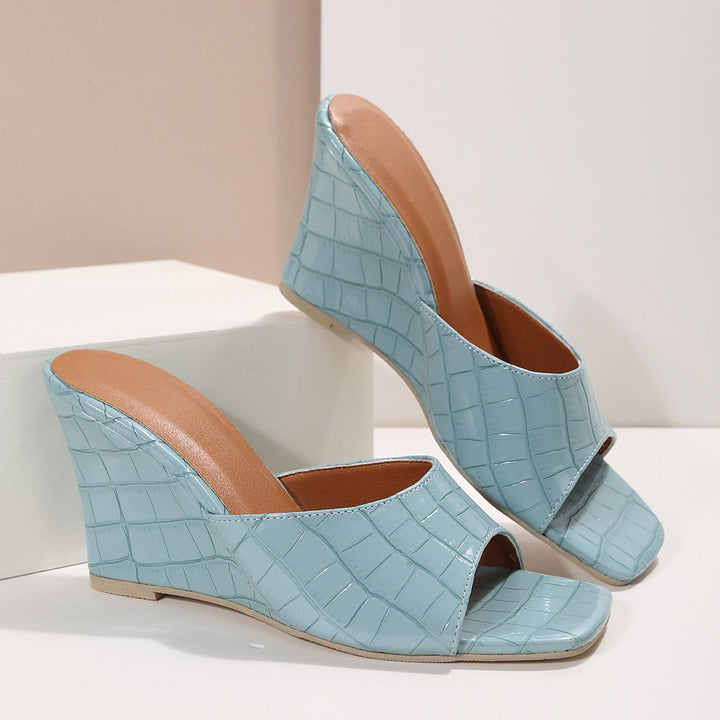 Front view of Eden women's snake-effect faux leather wedge shoe in nude