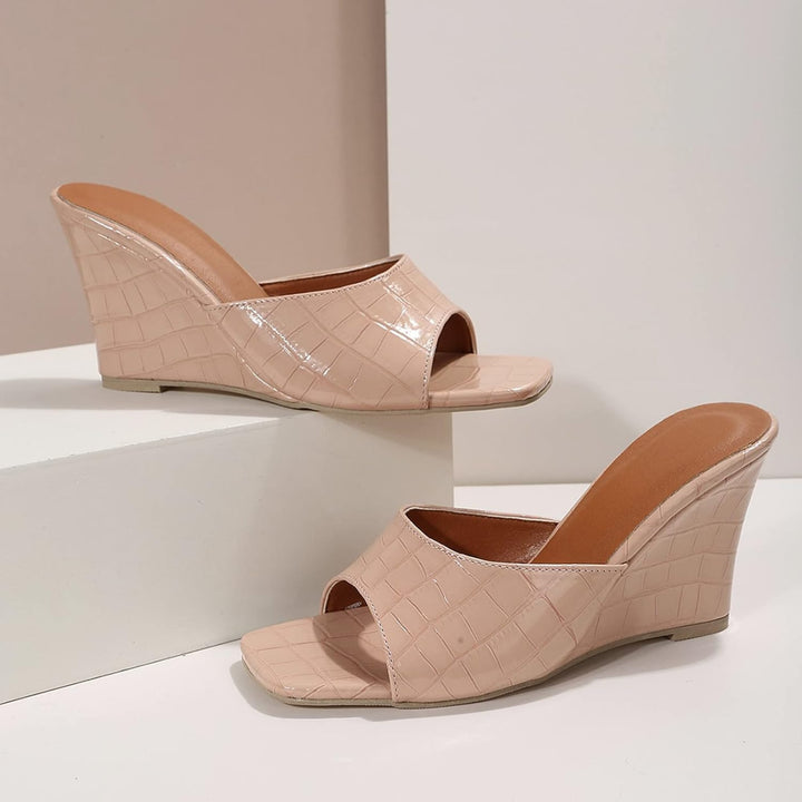 Eden blue wedge shoe pair styled on white surface