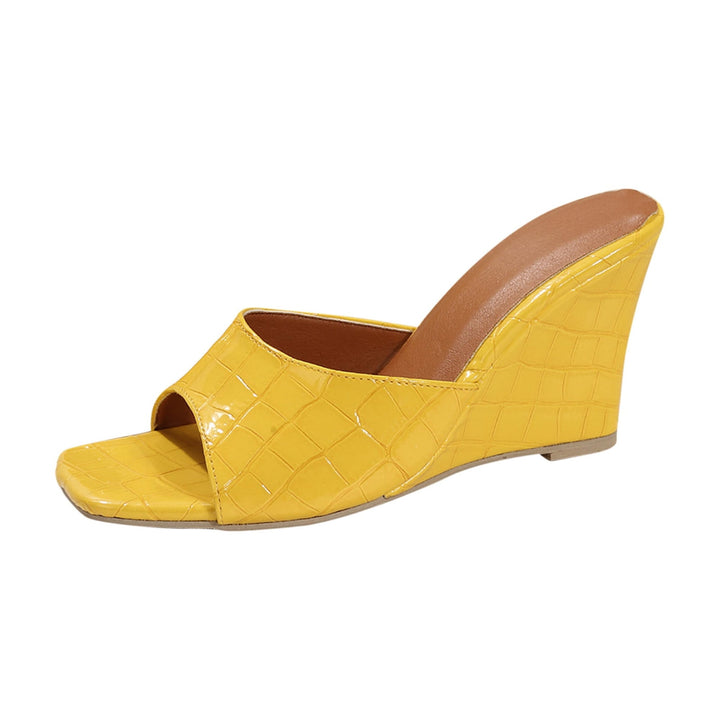 Pair of Eden wedge shoes in black displayed on a flat surface