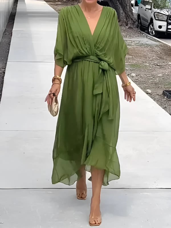 Front view of the Eden flowy midi dress in green showing the adjustable wrap neckline and midi length
