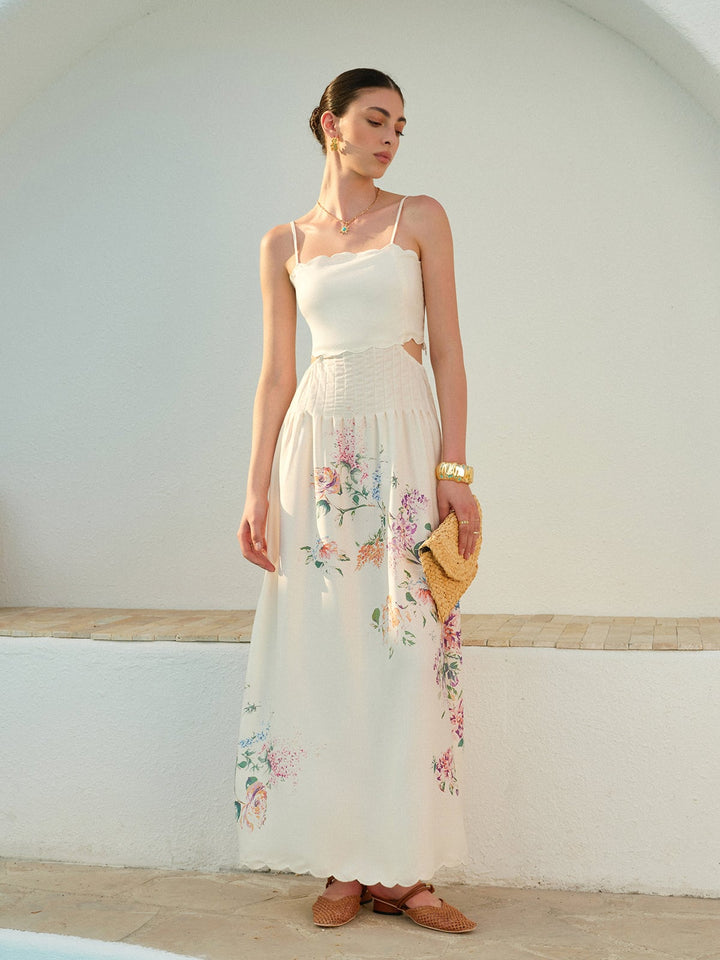 Side view of the Eden floral maxi dress showing the cutout waist detail and pleated skirt