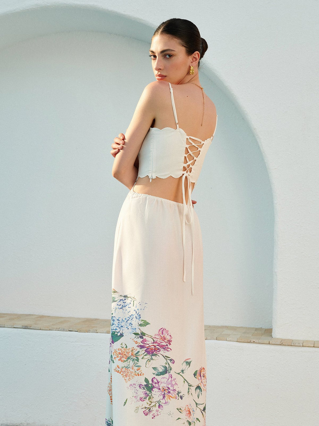 Woman wearing the Eden floral maxi dress outdoors in natural light, showcasing the botanical print