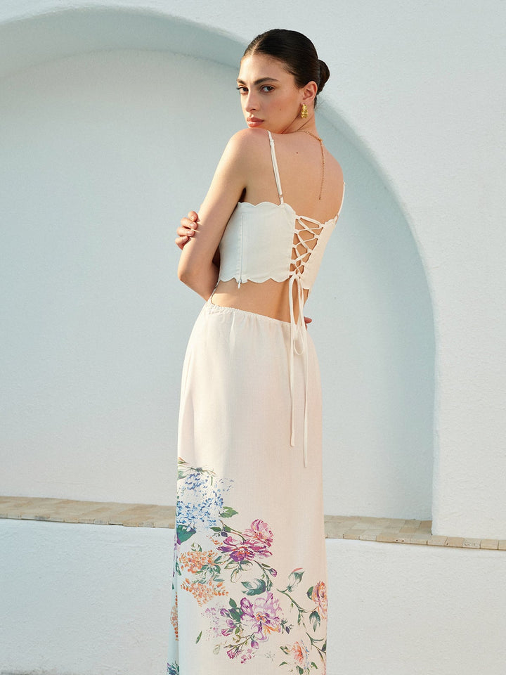 Woman wearing the Eden floral maxi dress outdoors in natural light, showcasing the botanical print