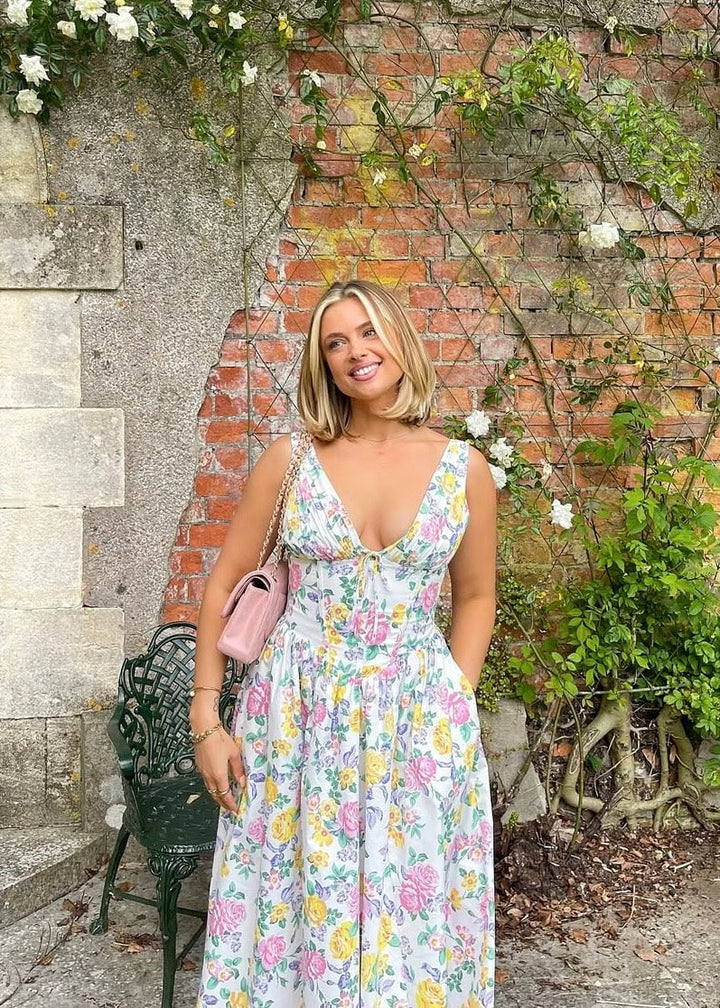 Side view of the Edith elegant summer dress in yellow floral, showing the breezy fit and skirt movement